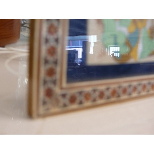 25 - A MINIATURE PERSIAN SIGNED PAINTING ON PORCELAIN IN A WOODEN INLAID MOSAIC FRAME