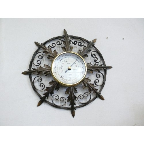 146 - AN ORNATE METAL FRAMED BAROMETER