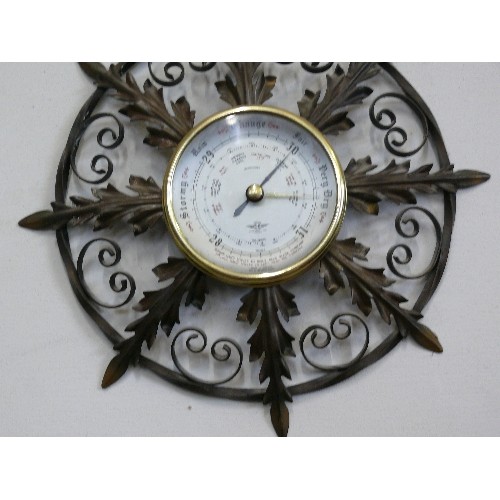 146 - AN ORNATE METAL FRAMED BAROMETER