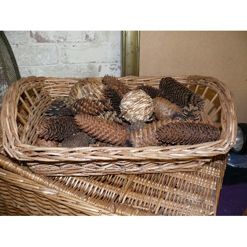 253 - A LARGE WICKER BASKET PLUS A SMALLER ONE WITH CONTENTS OF DECORATIVE PINE CONES