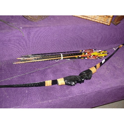 252 - A CARVED WOODEN BOW WITH RED INDIAN AND A SELECTION OF ARROWS