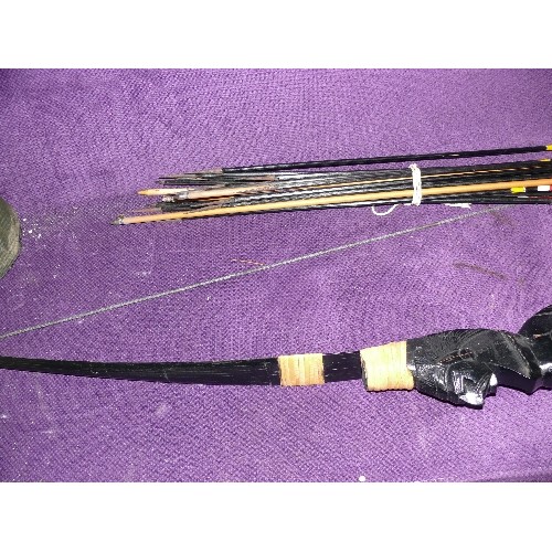 252 - A CARVED WOODEN BOW WITH RED INDIAN AND A SELECTION OF ARROWS