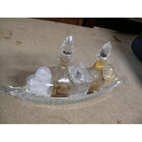 285 - A VINTAGE GLASS BOAT SHAPED CONDIMENT SET