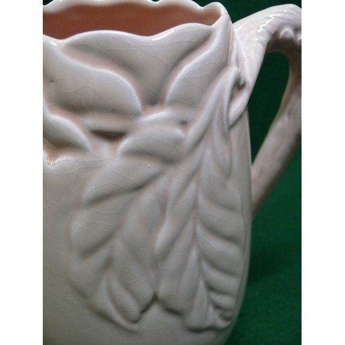 1 - A LARGE CLARICE CLIFF JUG WITH LEAF DESIGN 10 INCHES TALL IN LIGHT APRICOT