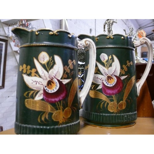 293C - 2 PITCHER JUGS BLACK WITH HAND PAINTED ORCHIDS