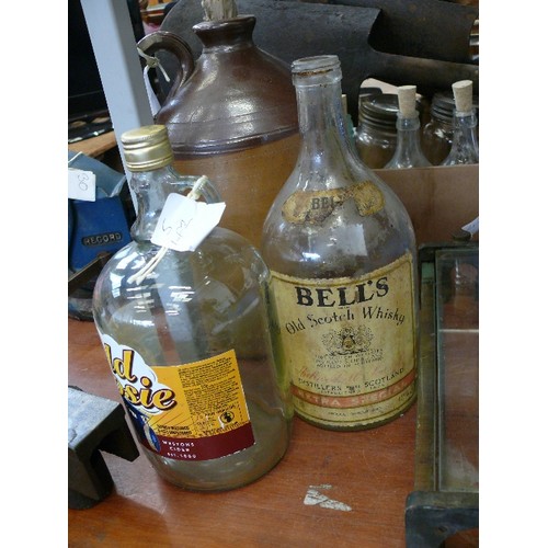 205 - 2 OLD GLASS FLASKS 1 'OLD ROSIE' AND 1 BELLS WHISKEY