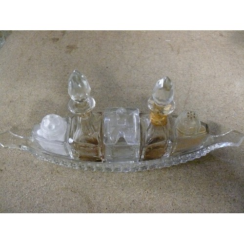 285 - A VINTAGE GLASS BOAT SHAPED CONDIMENT SET