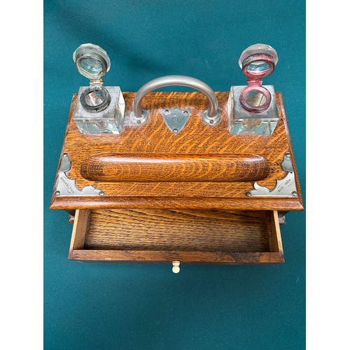 301 - An Oak Desk Stand with with a pair of cut glass inkwells and a drawer. Presentation inscription 1924