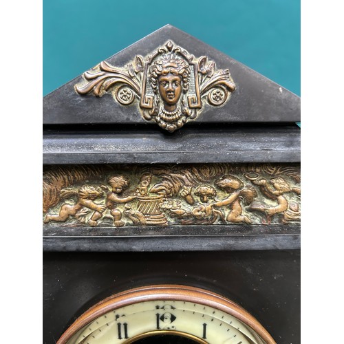 363 - A Large Victorian black slate mantel clock with brass columns and brass plaques with classical scene... 