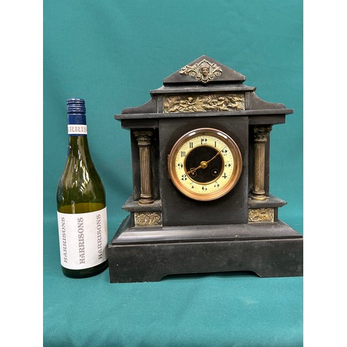 363 - A Large Victorian black slate mantel clock with brass columns and brass plaques with classical scene... 