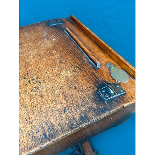 463 - A circa 1920's child's folding desk, with good original patina to the wood. Brass inkwell cap