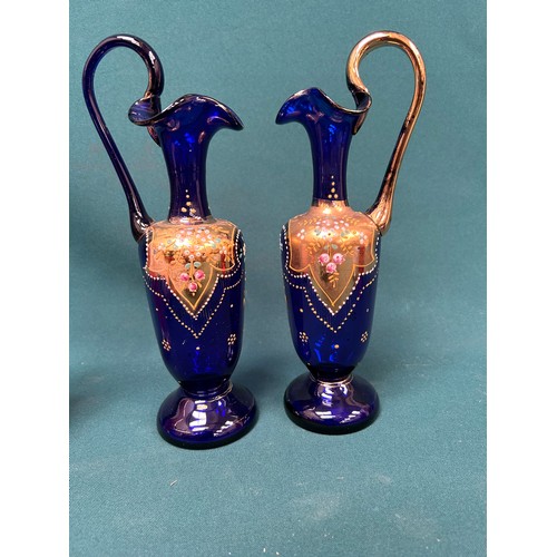 203 - A pair of Victorian cobalt blue glass ewer shaped vases overlaid with gilt decoration, a pink Caithn... 