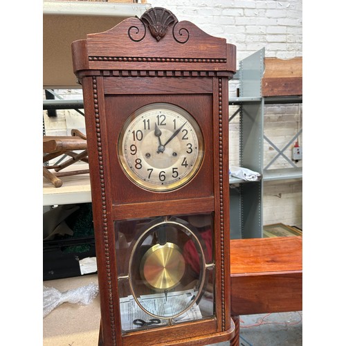 356 - A circa 1930's wall clock in an oak case. The movement by the Hamburg American Clock Company with cr... 