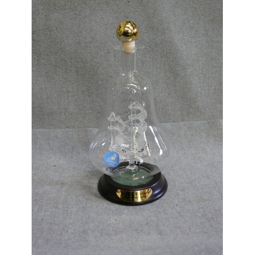 90 - A MODEL OF HMS VICTORY IN AN UNUSUAL BELL SHAPED BOTTLE