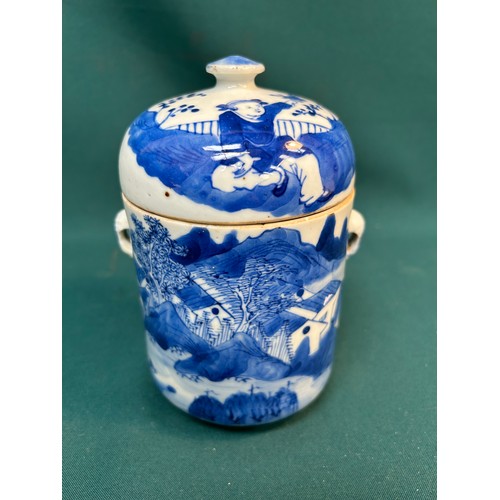 390 - An early 20th Century Chinese blue and white lidded jar or tea caddy hand decorated with a village s... 