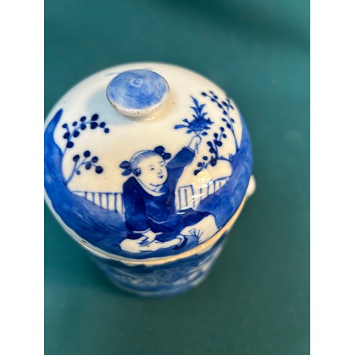 390 - An early 20th Century Chinese blue and white lidded jar or tea caddy hand decorated with a village s... 