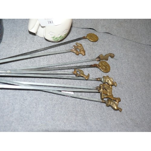 181 - A SET OF SKEWERS WITH DECORATIVE BRASS TOPS PLUS AN ORIENTAL LADY FIGURE AND A MOTHER OF PEARL SHELL