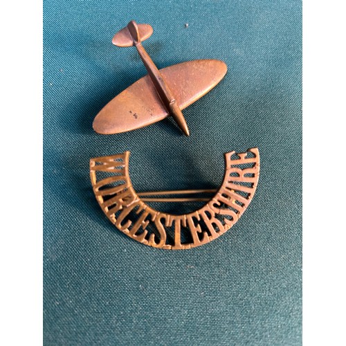 103 - A WW2 Trench art pin aeroplane pin brooch and a Worcestershire Regiment shoulder title