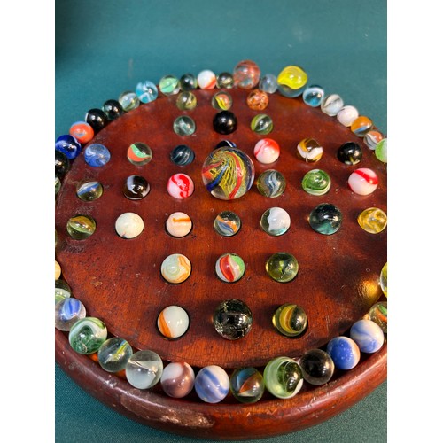 305 - An Antique mahogany solitaire board with a good collection of antique and vintage glass marbles