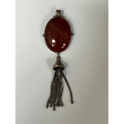 43 - A heavy silver pendant with large carnelian cabochon and tassel - 11cm