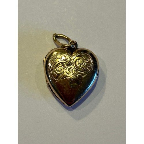 86 - A vintage heart shaped locket marked 