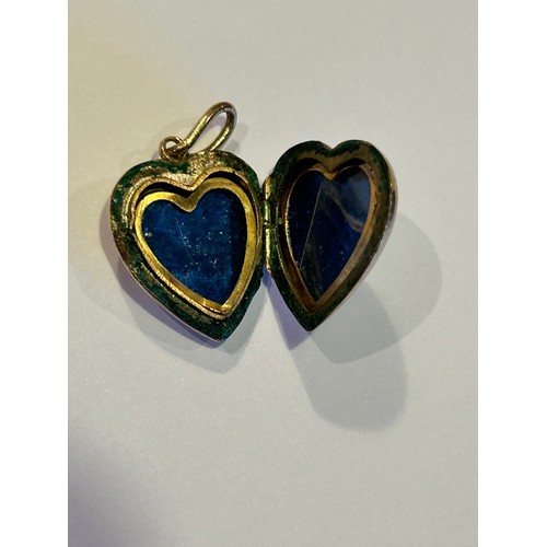 86 - A vintage heart shaped locket marked 