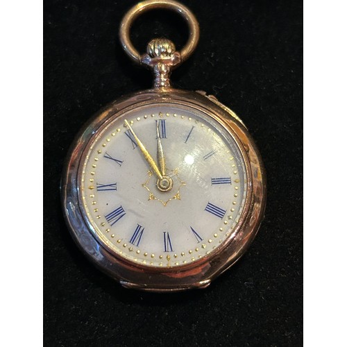 65 - A beautiful 14ct Gold Victorian Swiss ladies fob watch, enamel dial with blue roman numerals, engrav... 