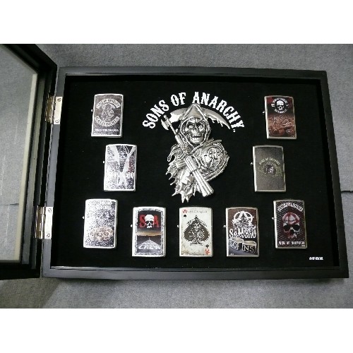 44 - A COLLECTION OF 9 SONS OF ANARCHY IN DISPLAY CASE  ZIPPO STYLE LIGHTERS