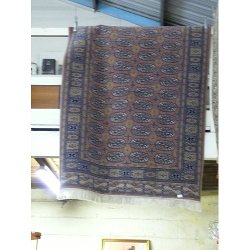 394 - A LARGE PATTERENED  RUG