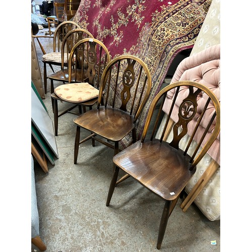 495 - 4 ERCOL DINING CHAIRS AND A MATCHING CARVER CHAIR - WINDSOR STYLE WITH FLEUR DE LYS PANEL TO BACK SP... 