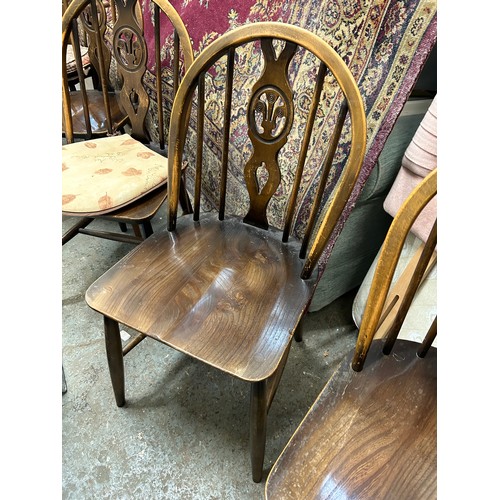 495 - 4 ERCOL DINING CHAIRS AND A MATCHING CARVER CHAIR - WINDSOR STYLE WITH FLEUR DE LYS PANEL TO BACK SP... 