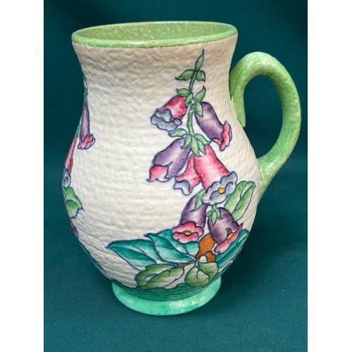 211 - A beautiful 1930's Charlotte Rhead jug for Crown Ducal, tube lined in the foxglove pattern - 22cm