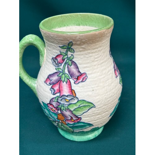 211 - A beautiful 1930's Charlotte Rhead jug for Crown Ducal, tube lined in the foxglove pattern - 22cm