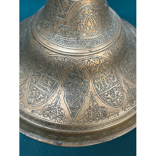 291 - A very large Persian engraved brass candlestick, probably 19th Century Qajar dynasty. The base finel... 