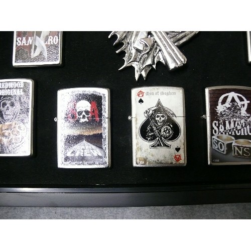 44 - A COLLECTION OF 9 SONS OF ANARCHY IN DISPLAY CASE  ZIPPO STYLE LIGHTERS