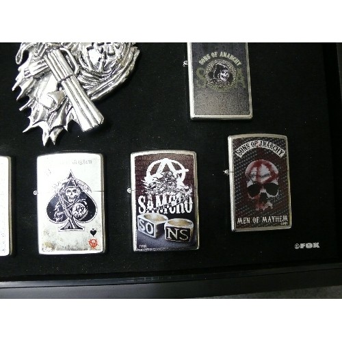 44 - A COLLECTION OF 9 SONS OF ANARCHY IN DISPLAY CASE  ZIPPO STYLE LIGHTERS