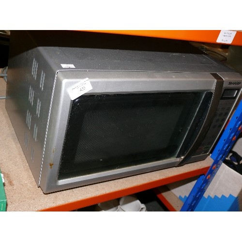 425 - SHARP MICROWAVE IN STEEL GREY WITH OPERATING MANUAL