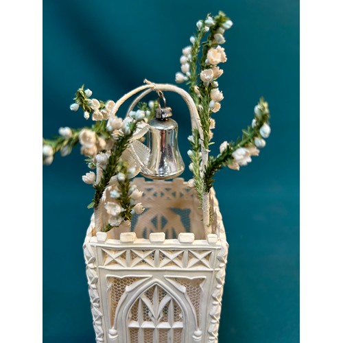 228 - An unusual 1950's Wedding Cake decoration in the form of a church tower topped with a lily of the va... 