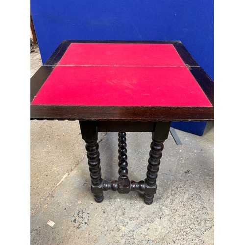 436 - An unusual Victorian Oak fold over card table with carved top and bobbin turned legs. The top hinged... 