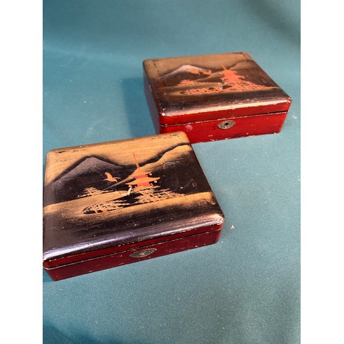 396 - A graduated pair of early 20th Century Japanese lacquered trinket boxes with Pagodas, birds and Moun... 