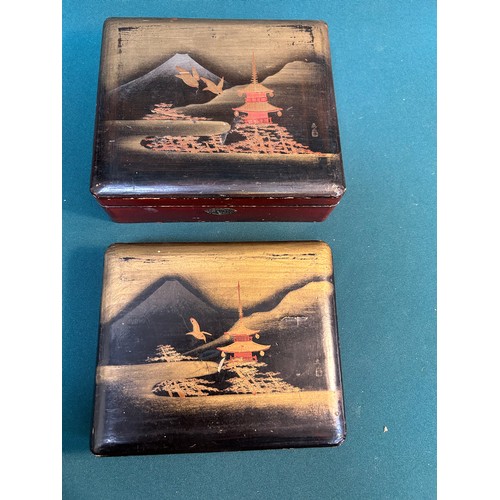 396 - A graduated pair of early 20th Century Japanese lacquered trinket boxes with Pagodas, birds and Moun... 