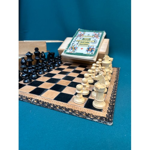 130 - A wooden Staunton type chess set with leather covered board, a game of Bezique, 2 boxed sets of bone... 