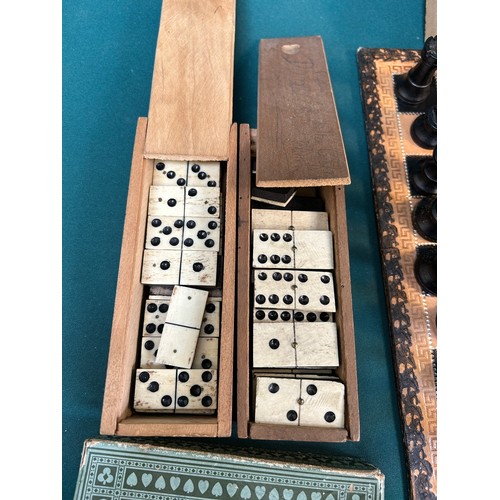 130 - A wooden Staunton type chess set with leather covered board, a game of Bezique, 2 boxed sets of bone... 