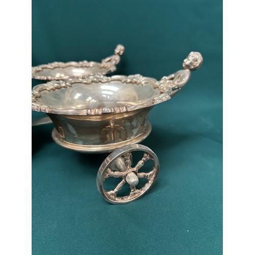 278 - A Vintage silver plated triple decanter wagon on wheels in the Georgian style. The three coasters wi... 