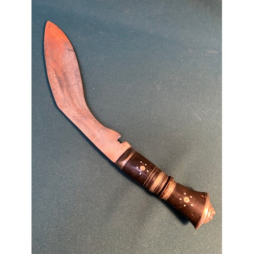 323 - A mid century Indian Khukuri knife the ebony handle inlaid with metal and with lion head butt. Blade... 