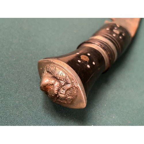 323 - A mid century Indian Khukuri knife the ebony handle inlaid with metal and with lion head butt. Blade... 