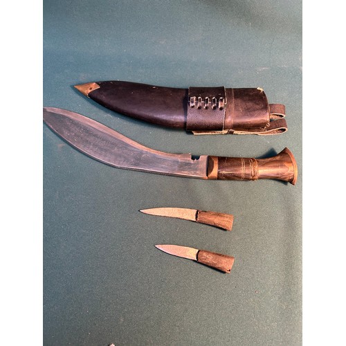 322 - A mid century Gurkha Nepalese Khukuri knife in leather covered scabbard, with horn handle,  together... 