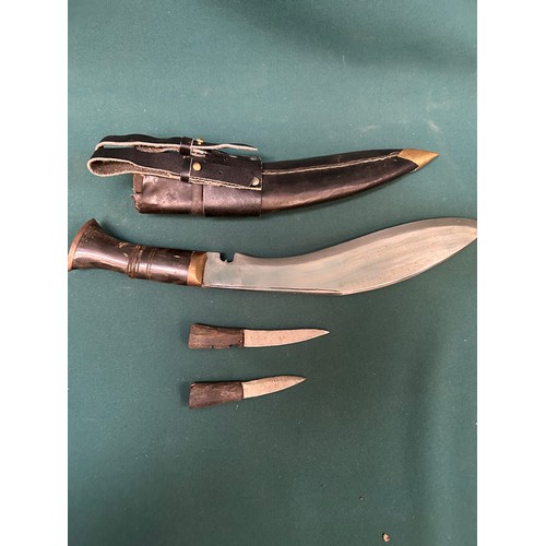 322 - A mid century Gurkha Nepalese Khukuri knife in leather covered scabbard, with horn handle,  together... 