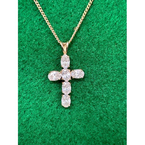 88 - A 9ct Gold Cross set with 6 baguette shaped white stones on a 9ct gold chain - chain 48cm