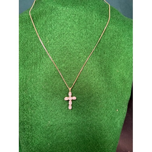88 - A 9ct Gold Cross set with 6 baguette shaped white stones on a 9ct gold chain - chain 48cm